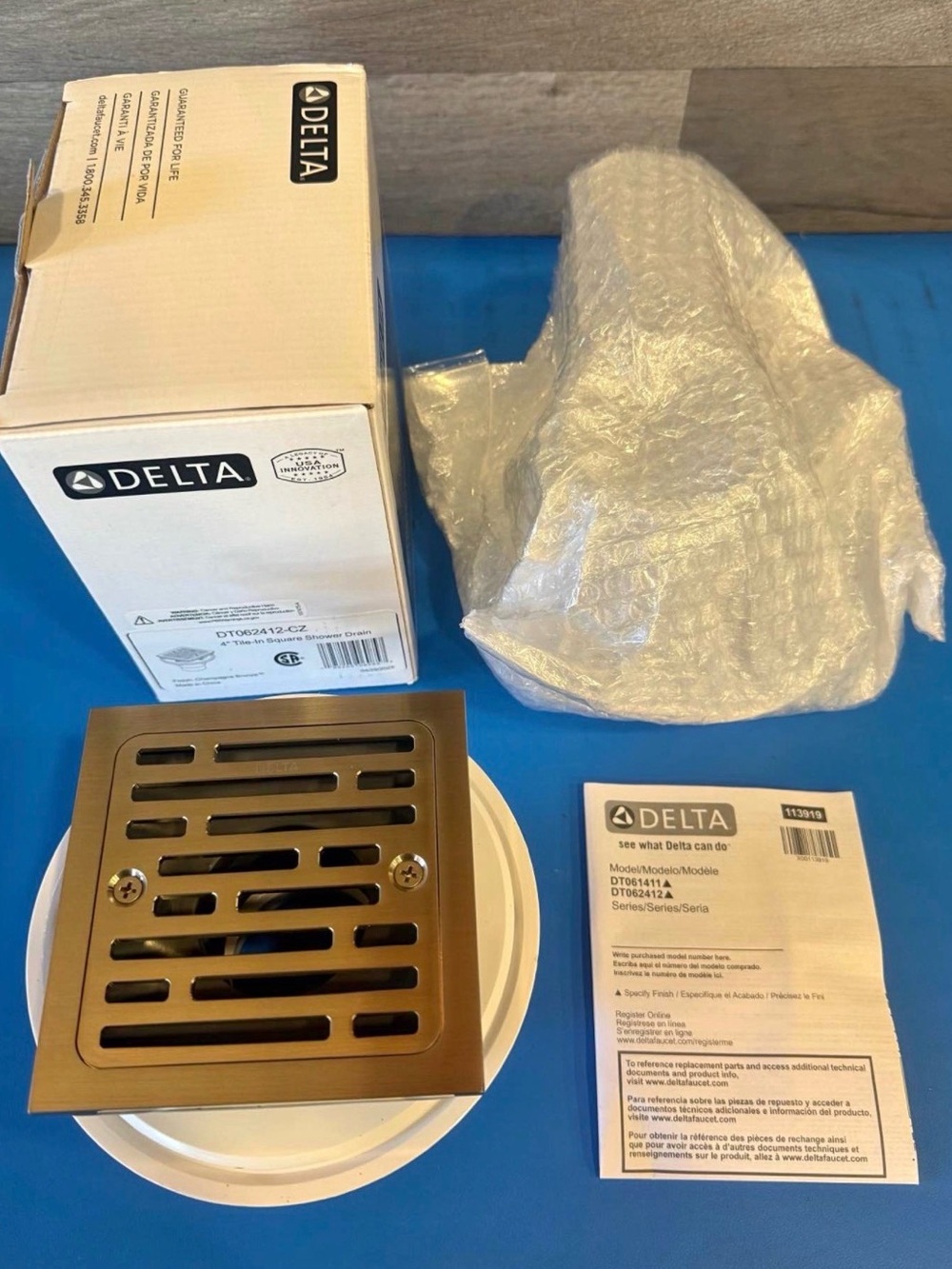 Brand New Delta 4-in Brass Square Shower Drain in Champagne Bronze